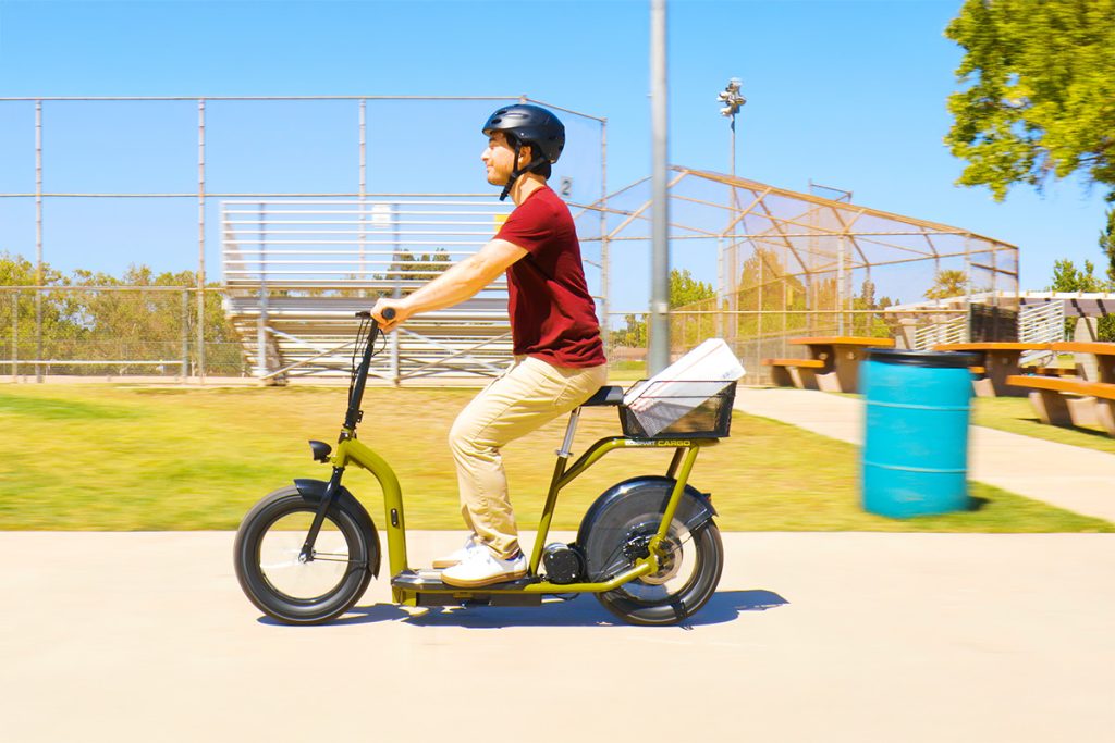 Helmeted adult riding the Razor EcoSmart Cargo seated electric scooter