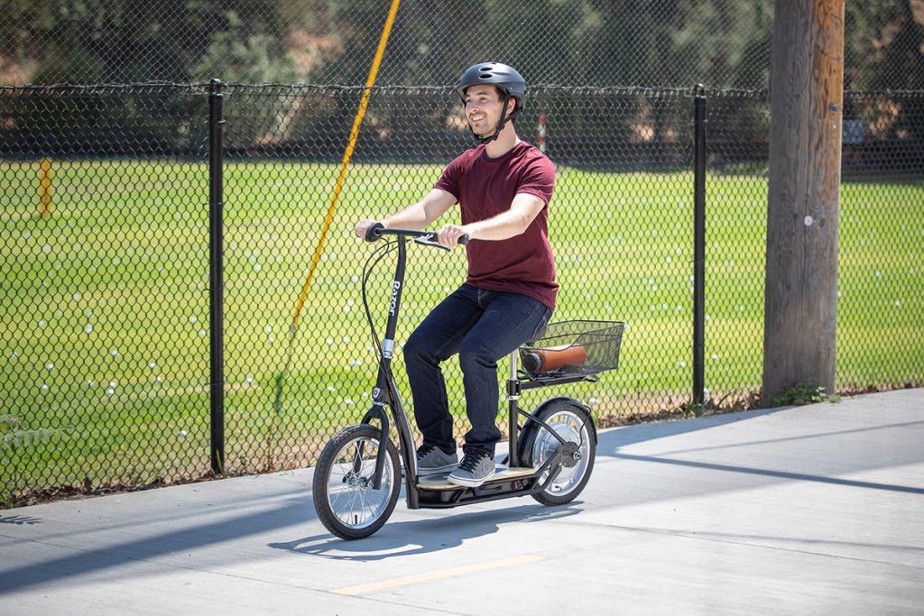 Helmeted adult riding the Razor EcoSmart Metro HD seated electric scooter