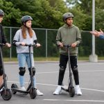 Teens ages 13 to 15 wearing helmets beside electric scooters during adult safety instruction