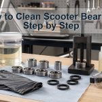 Unbranded scooter wheel bearings shields spacers cleaning jar and lubricant arranged safely