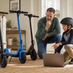 Parent and child comparing online listings for kids electric scooters without brand logos