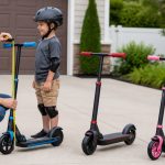 Parent measuring handlebars on kids electric scooters priced below two hundred dollars